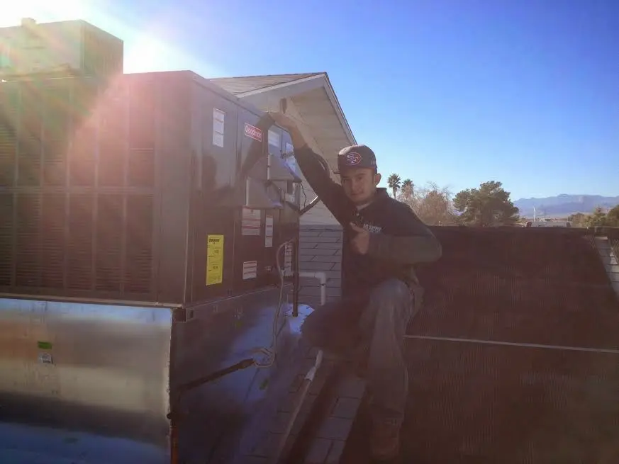 HVAC technician performing Boiler Repair on a rooftop unit in Centerville